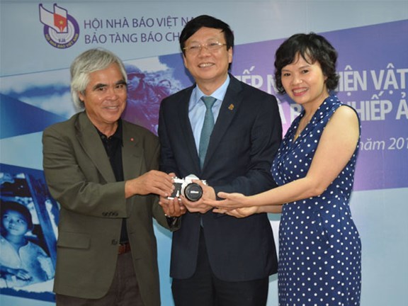 Đại diện Hội Nhà báo Việt Nam và Bảo tàng Báo chí tiếp nhận hiện vật của nhiếp ảnh gia Nick Út  trao tặng.